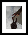 Peace Gesture Against Skyscraper - Framed Print