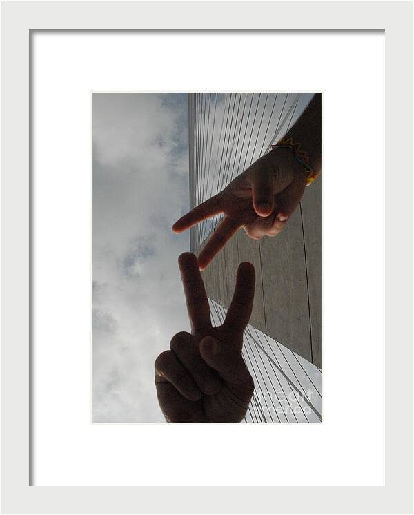 Peace Gesture Against Skyscraper - Framed Print