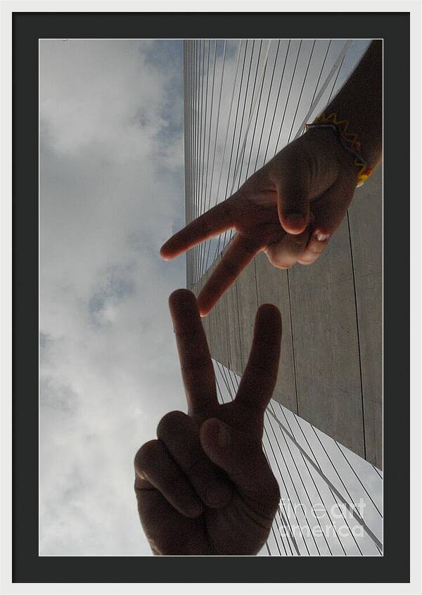 Peace Gesture Against Skyscraper - Framed Print